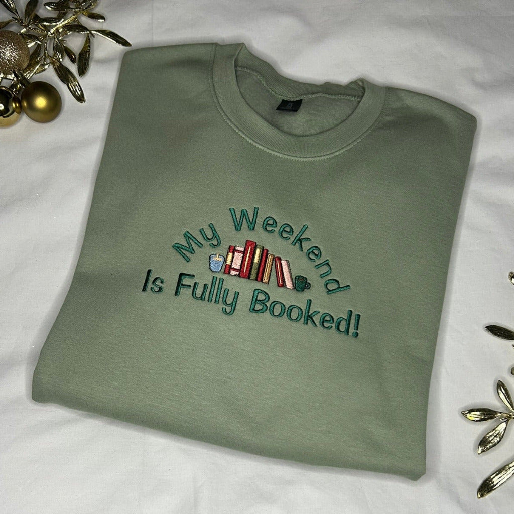 Sweatshirt with exclaiming 'My Weekend is Fully Booked!' with an array of books